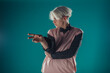 © qunica.com - Young adult man in casual outfit wear looking at camera, holding skateboard near face and standing at studio on blue background