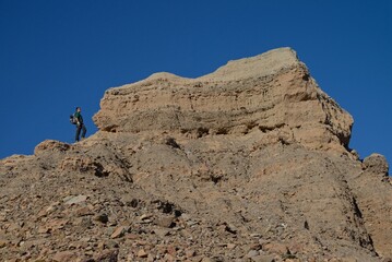 Wall Mural - Man climbing hill, Mojave Desert, California, USA, MR
