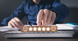 © andranik123 - Man showing smiling face and five stars on wooden block. Feedback. Customer satisfaction