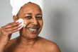 © Alessandro Biascioli - Happy African senior woman having skin care spa day - People wellness lifestyle concept