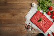 © New Africa - Raw fresh minced meat, tomatoes and other ingredients on wooden table, flat lay. Space for text
