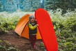 Child with sleeping pad family camping tent gear travel adventure vacations hiking equipment outdoor in forest healthy lifestyle eco tourism