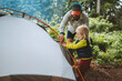 © EVERST - Child and father are pitching camping tent family travel vacations hiking outdoor adventure trip healthy lifestyle eco tourism
