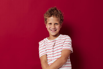 Wall Mural - little boy with curly hair posing isolated background