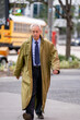 Businessman with an oversize trenchcoat walking in the city