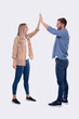 © Alex - Young Couple Making High Five Standing Isolated. Sign