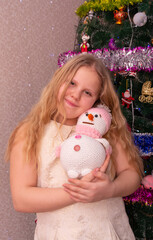 Wall Mural - A beautiful elegant girl near the Christmas tree in the New Year