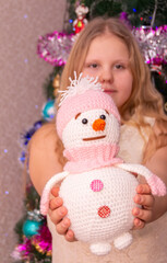 Wall Mural - A beautiful elegant girl near the Christmas tree in the New Year