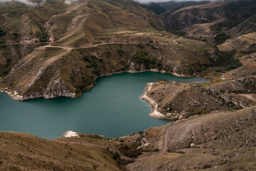 Wall Mural - mountain lake with turquoise water on a cloudy day. elbrus region