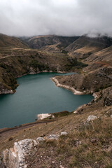Wall Mural - mountain lake with turquoise water on a cloudy day. elbrus region