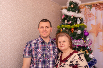 Poster - Mom and son near the Christmas tree. 