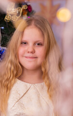 Wall Mural - A beautiful elegant girl near the Christmas tree in the New Year