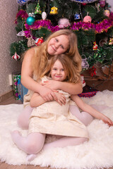 Poster - Two beautiful little sisters near the Christmas tree.