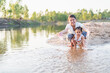 © Subhakitnibhat - happy family Mother and little daughter playing in the water on the beach on a sunny day.