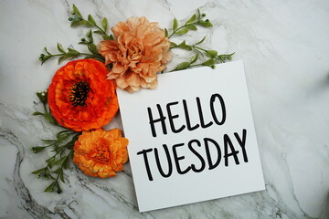 Canvas Print - Hello Tuesday text with orange flower bouquet on marble background