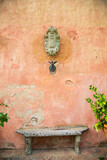 Fototapeta Sawanna - Fountains, terracotta walls and tall trees of a Tuscan villa, Italy