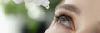 Woman drips eye drops into eye for allergies closeup