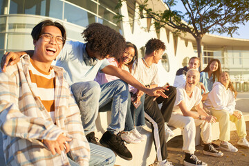 Wall Mural - Teenagers young students community and friendship lifestyle concept. Happy people having fun together outdoors.