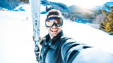 Happy Skier Taking Selfie Pic With Smart Cell Phone Device Outside - Young Man Having Fun On Weekend Activity In Ski Resort Vacation - Winter Sport Concept 