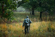 © Great Brut Here - Single Re-enactor Dressed As German Wehrmacht Infantry Soldier In World War II Walking In Patrol Through Autumn Forest. WWII WW2 Times.
