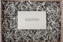 Shredded paper for product, gift and filling in a cardboard box. Sorry note. View from above. Theme for sending goods, postal services, online stores. Background, cardboard texture.