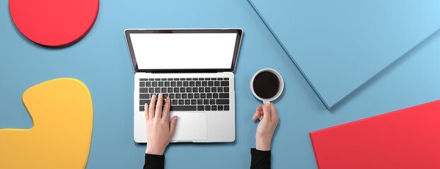 Poster - Person using a laptop computer with geometric shaped objects from above