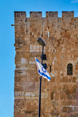 Wall Mural - waving flag of the state of israel near the wall of the old city of jerusalem and the temple mount on a sunny day, israel