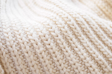 closeup beige knitted woolen fabric texture background