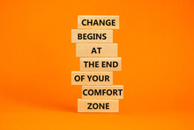 Out from comfort zone symbol. Wooden blocks with words Change begins at the end of your comfort zone. Beautiful orange table, orange background, copy space. Business, out from comfort zone concept.
