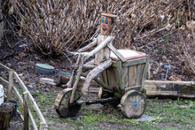 Wooden Handmade Bicycle And Human Figure Found In The Park, Selective Focus