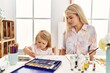 © Krakenimages.com - Mother and daughter smiling confident drawing on notebook at art studio