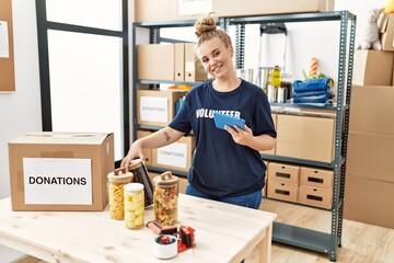 Poster - Young blonde girl wearing volunteer uniform working at charity center