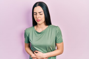 Poster - Beautiful woman with blue eyes wearing casual t shirt with hand on stomach because indigestion, painful illness feeling unwell. ache concept.