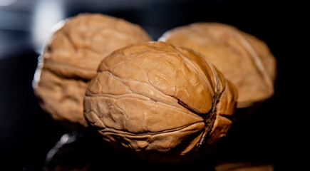 Sticker - Three walnuts on dark background