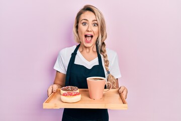 Sticker - Beautiful young blonde woman wearing waitress apron holding breakfast tray afraid and shocked with surprise and amazed expression, fear and excited face.