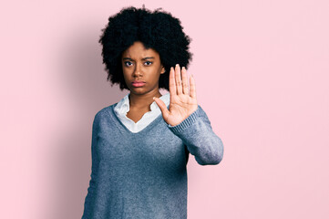 Wall Mural - Young african american woman wearing business clothes doing stop sing with palm of the hand. warning expression with negative and serious gesture on the face.