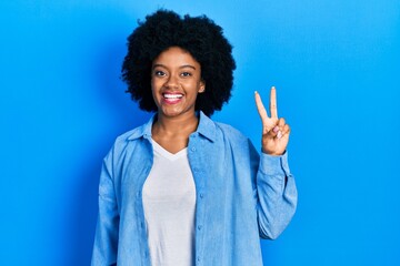 Young african american woman wearing casual clothes showing and pointing up with fingers number two while smiling confident and happy.