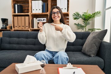 Poster - Young hispanic woman going to therapy at consultation office asking for help smiling happy pointing with hand and finger