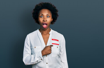 Poster - African american woman with afro hair wearing hello my name is sticker identification afraid and shocked with surprise and amazed expression, fear and excited face.