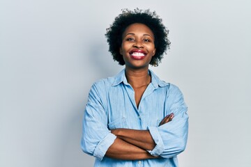 Sticker - Young african american woman wearing casual clothes happy face smiling with crossed arms looking at the camera. positive person.