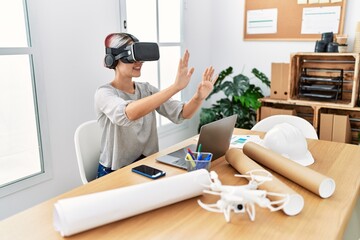 Sticker - Young caucasian architect woman working using virtual reality glasses at the office.