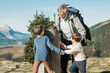 © ADDICTIVE STOCK - Grandfather and kids having fun during trekking in mountains
