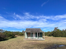 Wide-angle View Of An Old Abandoned Wooden House On The Grounds Of Cape Lookout National Seashore In The Outer Banks Of North Carolina