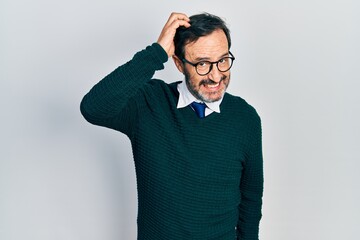 Wall Mural - Middle age hispanic man wearing casual clothes and glasses confuse and wonder about question. uncertain with doubt, thinking with hand on head. pensive concept.