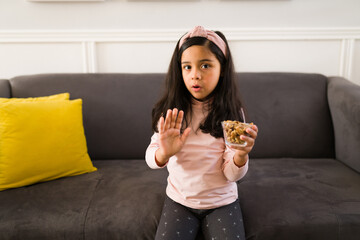 Wall Mural - Angry girl does not like walnuts