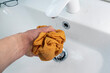 hand rinsing dirty cloth