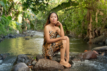 Wall Mural - Portrait of young girl in river, woman posing on the water 