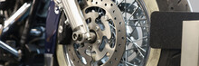 Front Motorcycle Wheel With Shiny Brake Disc Closeup