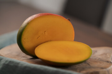 Wall Mural - Freshly cut ripe mango on olive board