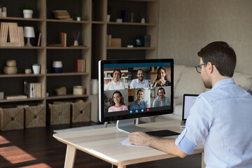 Wall Mural - focused young businessman entrepreneur manager holding distant video conference call conversation wi